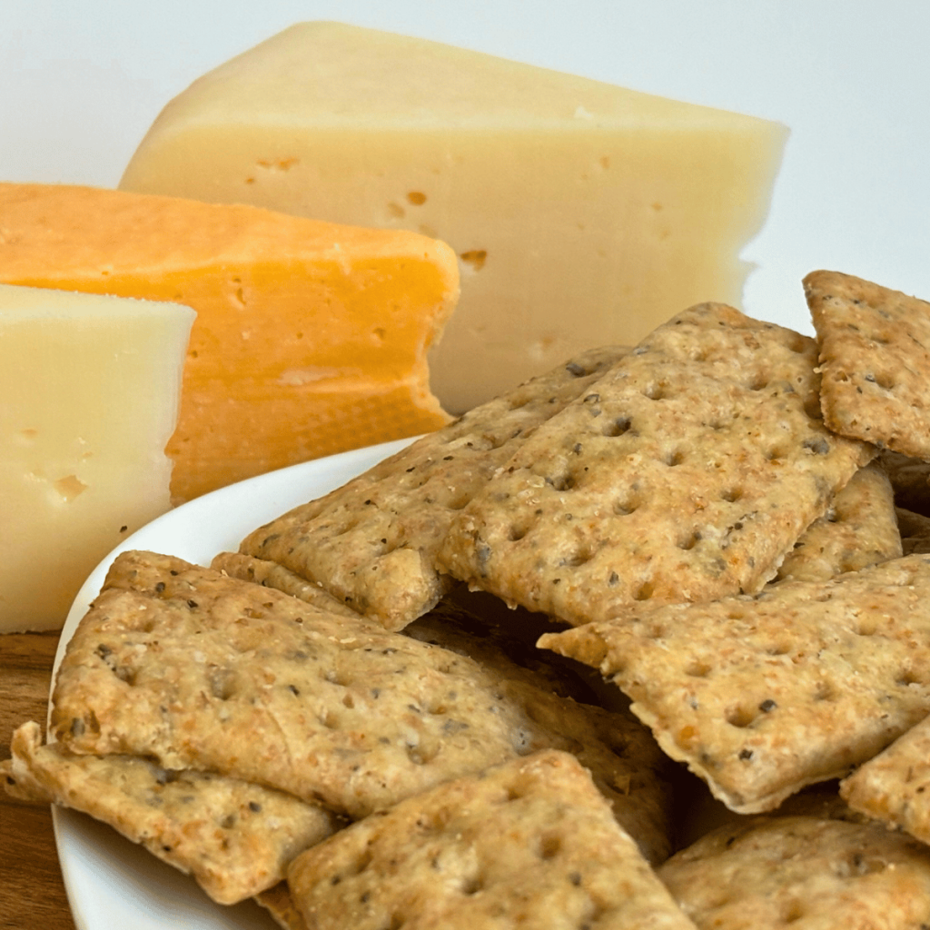 Sourdough discard crackers with cheese wedges.