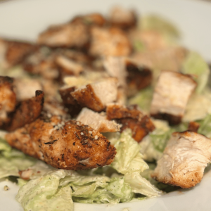Close up of Cajun Chicken on a Caesar salad.