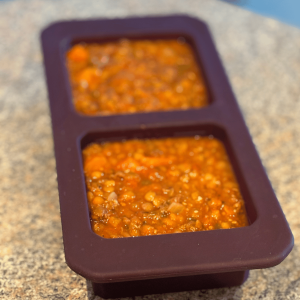 Two Cup Freezer cubes filled with Spicy Sausage Lentil Soup.
