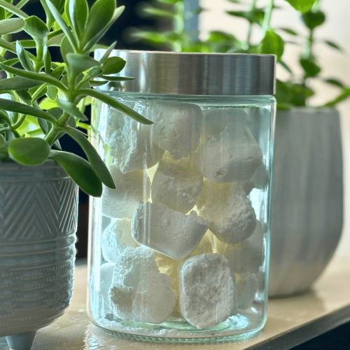 Glass jar filled with non-toxic dishwasher pods.