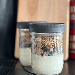 Pint jar layered with Instant Pot Greek yogurt, blueberries and granola.