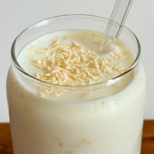 Glass with milk kefir topped with coconut.