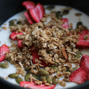 Bowl of Instant Pot Greek yogurt with granola and freeze dried strawberries.