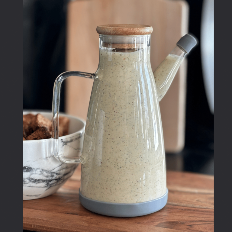 Container full of salad dressing.