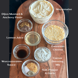 Glass bowls with ingredients needed for making Creamy Caesar Salad Dressing.
