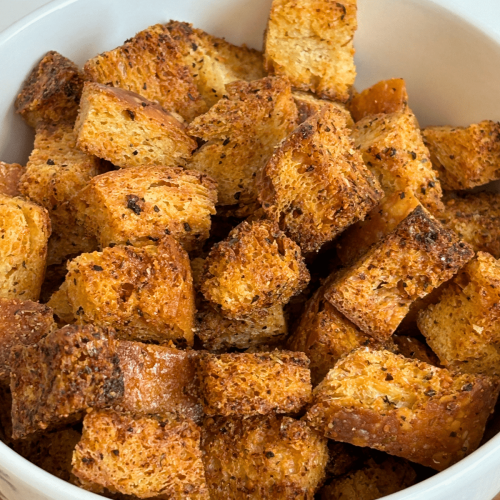 Close up of a bowl of Italian seasoned sourdough croutons.