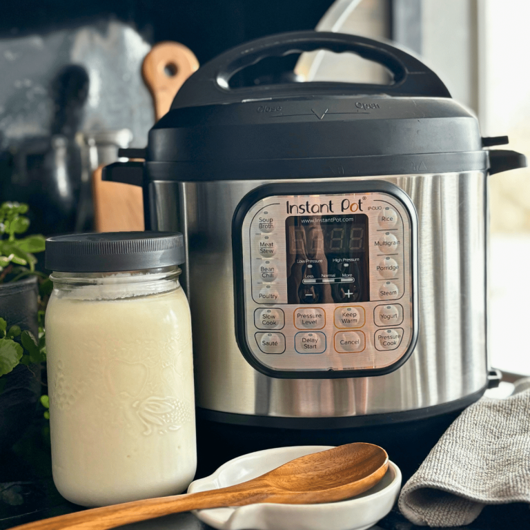 Instant Pot with a quart jar full of Greek yogurt.