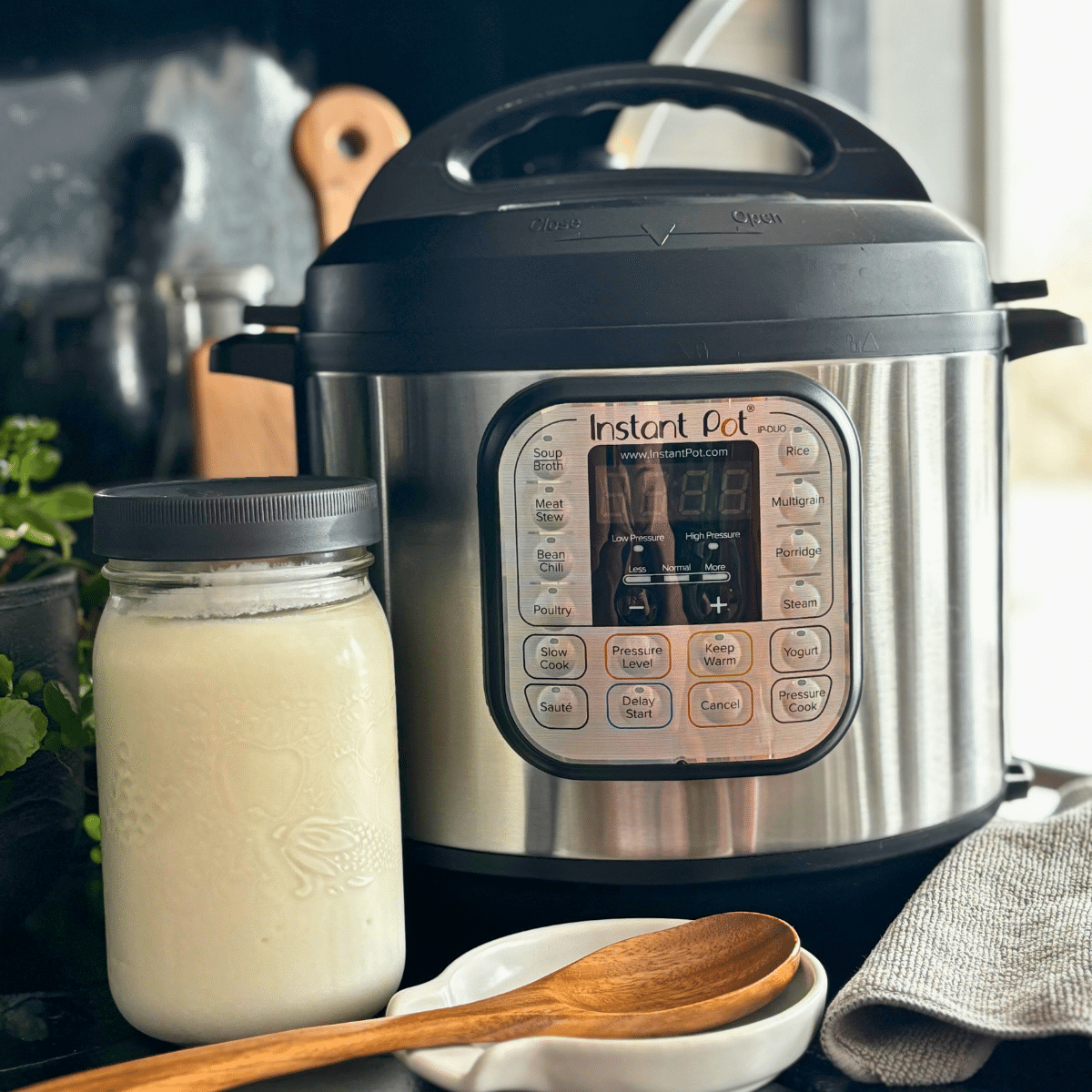 Instant Pot with a quart jar full of Greek yogurt.