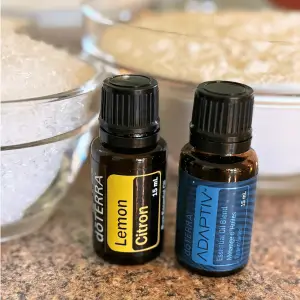 Bottle of doTERRA Lemon essential oil and a bottle of doTERRA Adaptiv essential oil.