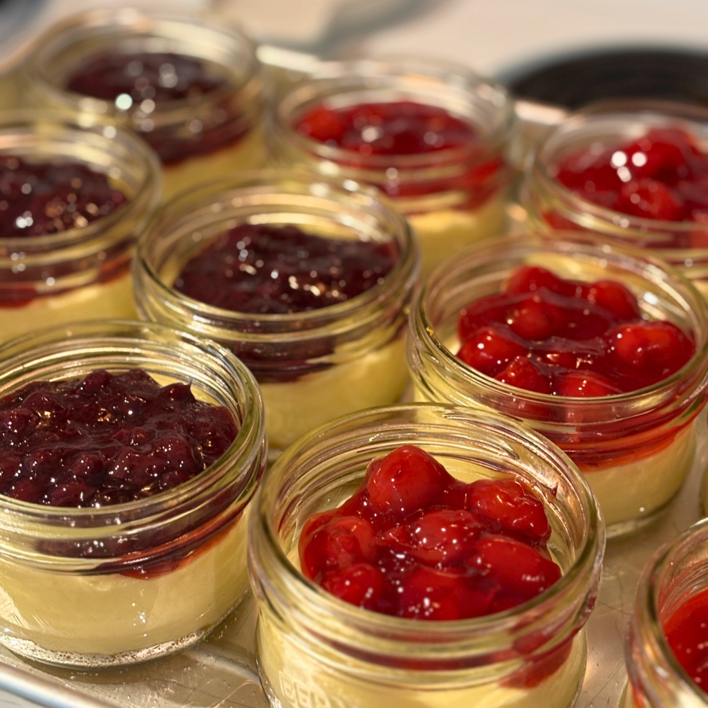 Cheesecake in a jar with two different kinds of toppings.