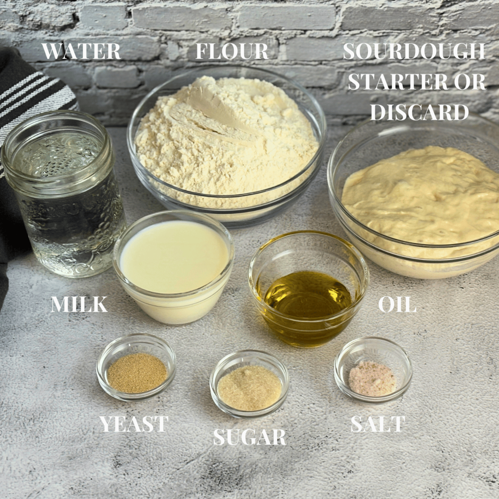 All ingredients for sourdough discard sandwich bread in bowls on the counter.