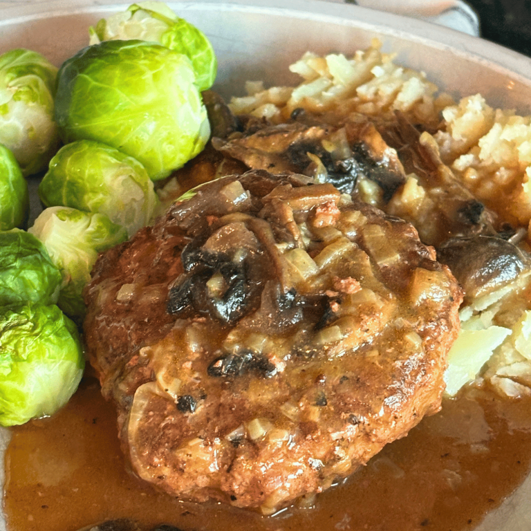 Instant Pot Salisbury Steak on a plate with Brussel sprouts