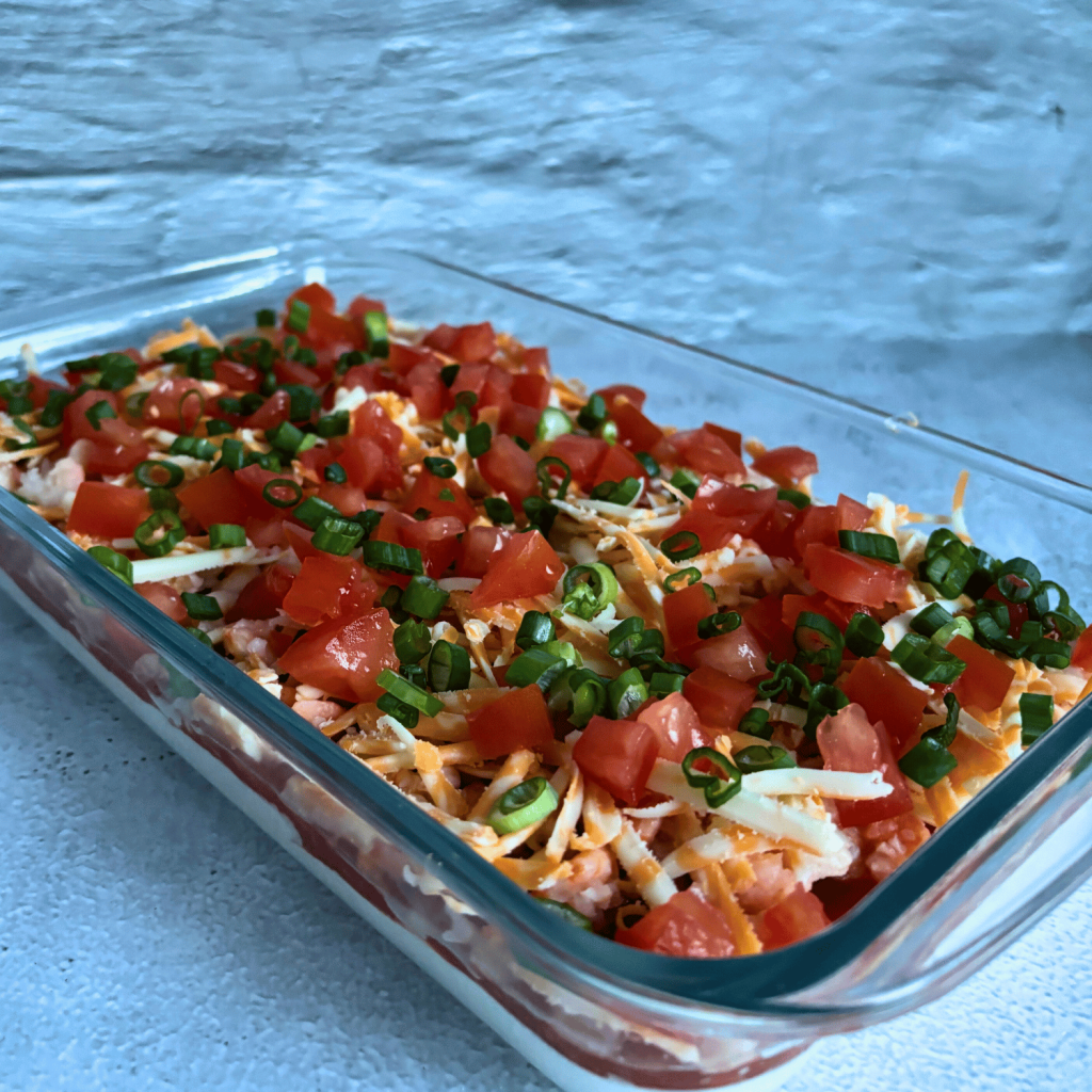 Complete glass dish of layered seafood dip.