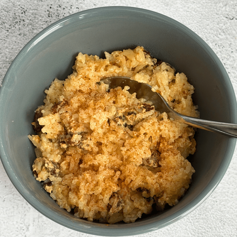Bowl of baked rice pudding in a grey bowl.
