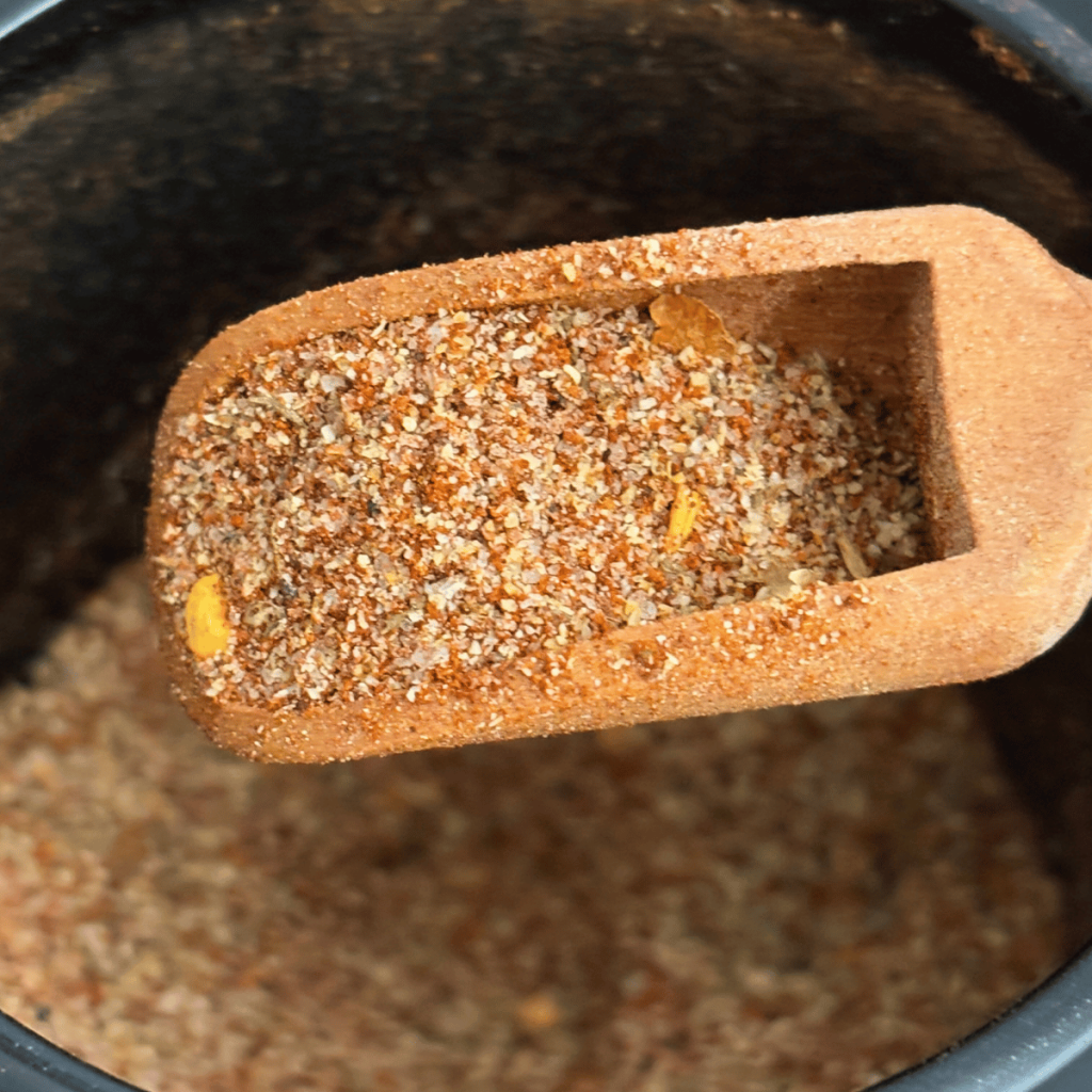 Close up picture of a scoop of homemade Cajun seasoning.