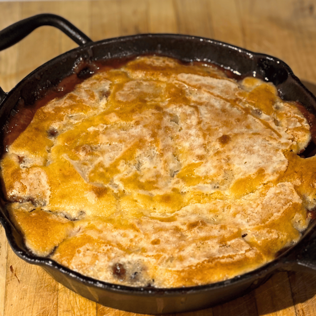 Strawberry-Rhubarb Pudding Cake in a cast iron skillet.