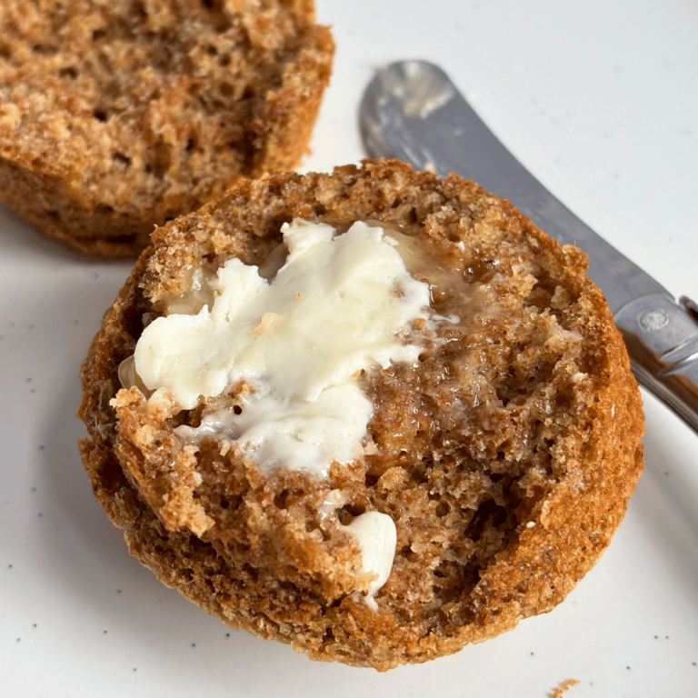 Cut open bran muffin with butter
