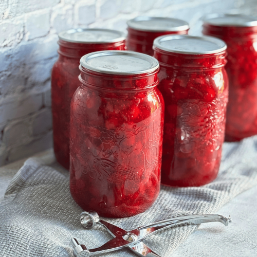Homemade Cherry Pie Filling cooling on a towel