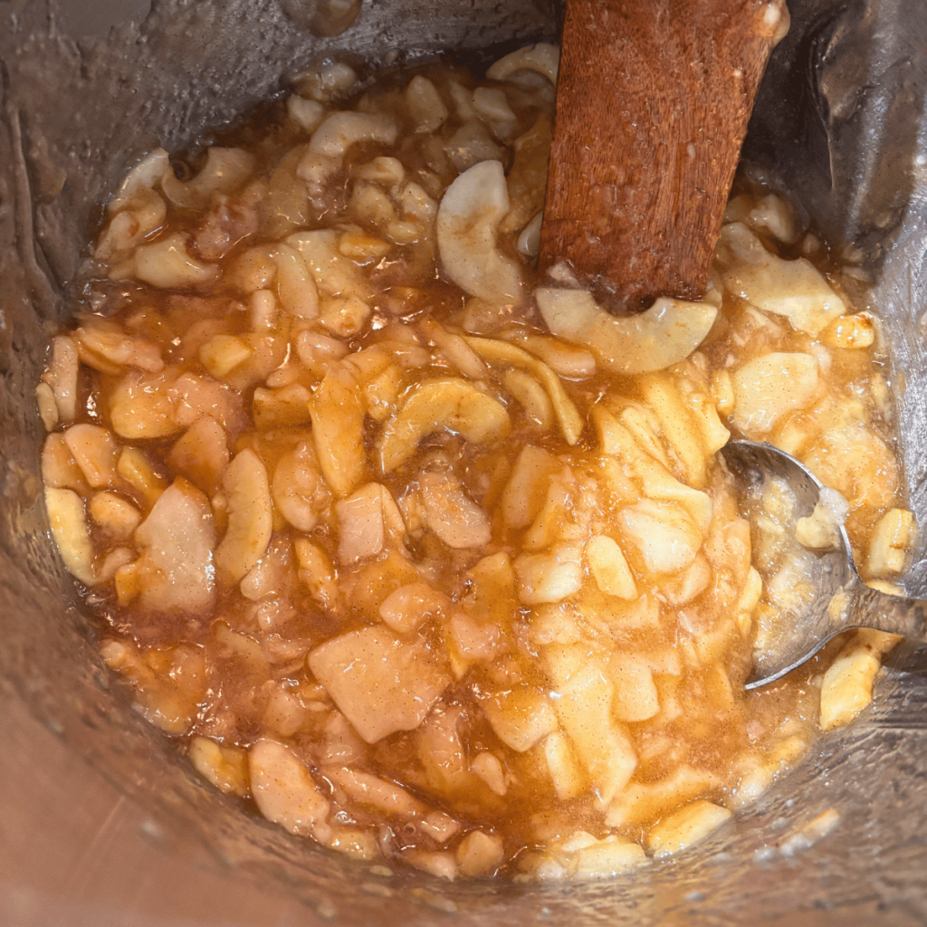 Homemade Apple Pie Filling cooking in a pot before being canned.