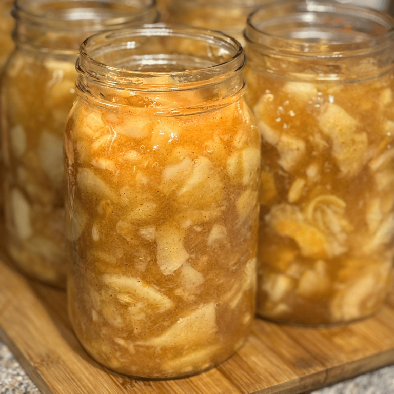 Quart jars filled with apple pie filling ready for lids.