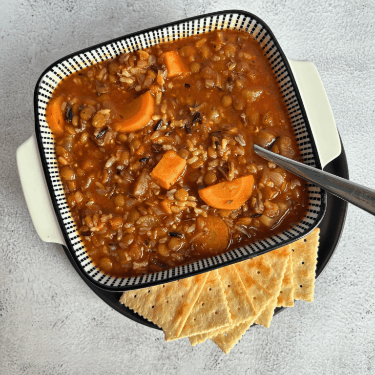 Lentil and Wild Rice soup in a bowl with crackers on the side