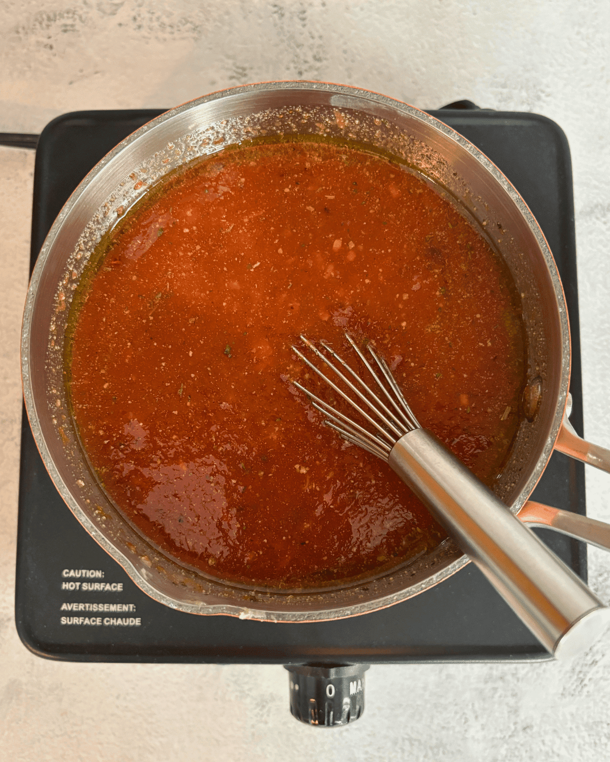 A pot of homemade pizza sauce.
