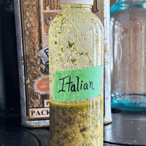 Glass bottle with golden Italian Salad dressing